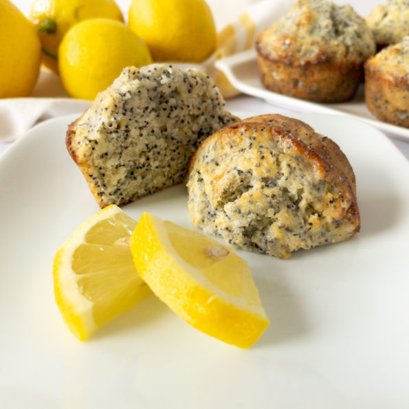 lemon poppy seed muffins cut in half with lemon slices