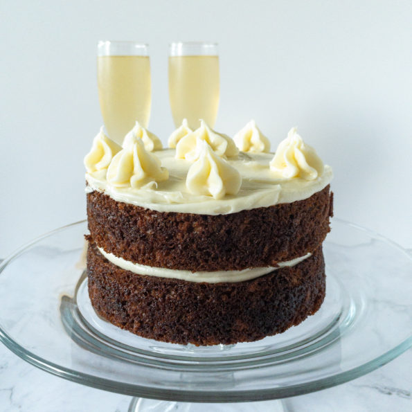 Frosted small carrot cake on cake stand
