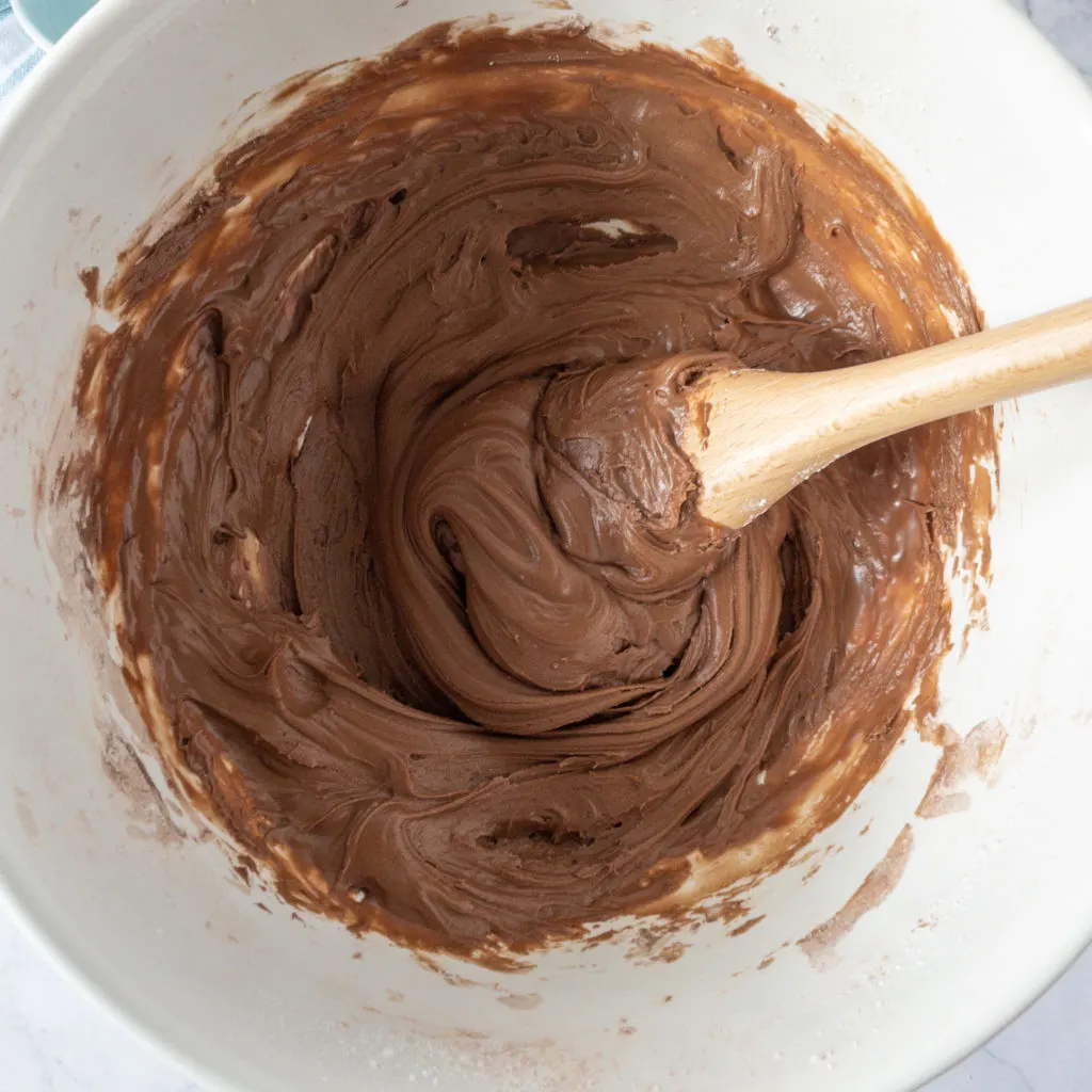 chocolate icing in bowl with spoon
