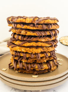 10 Anzac biscuits stacked on a plate