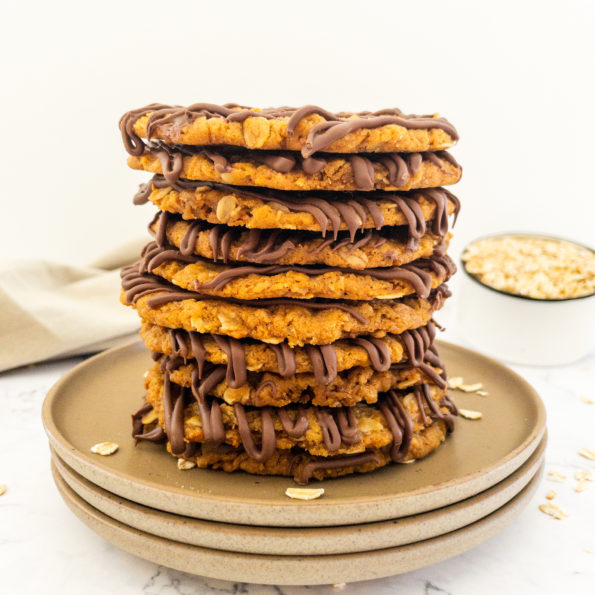 10 Anzac biscuits stacked on a plate