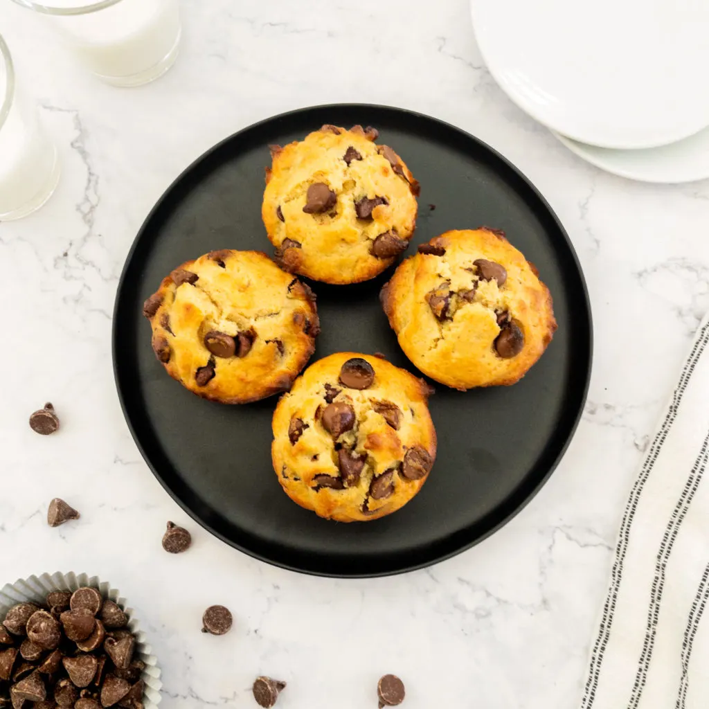 four chocolate chip muffins on plate