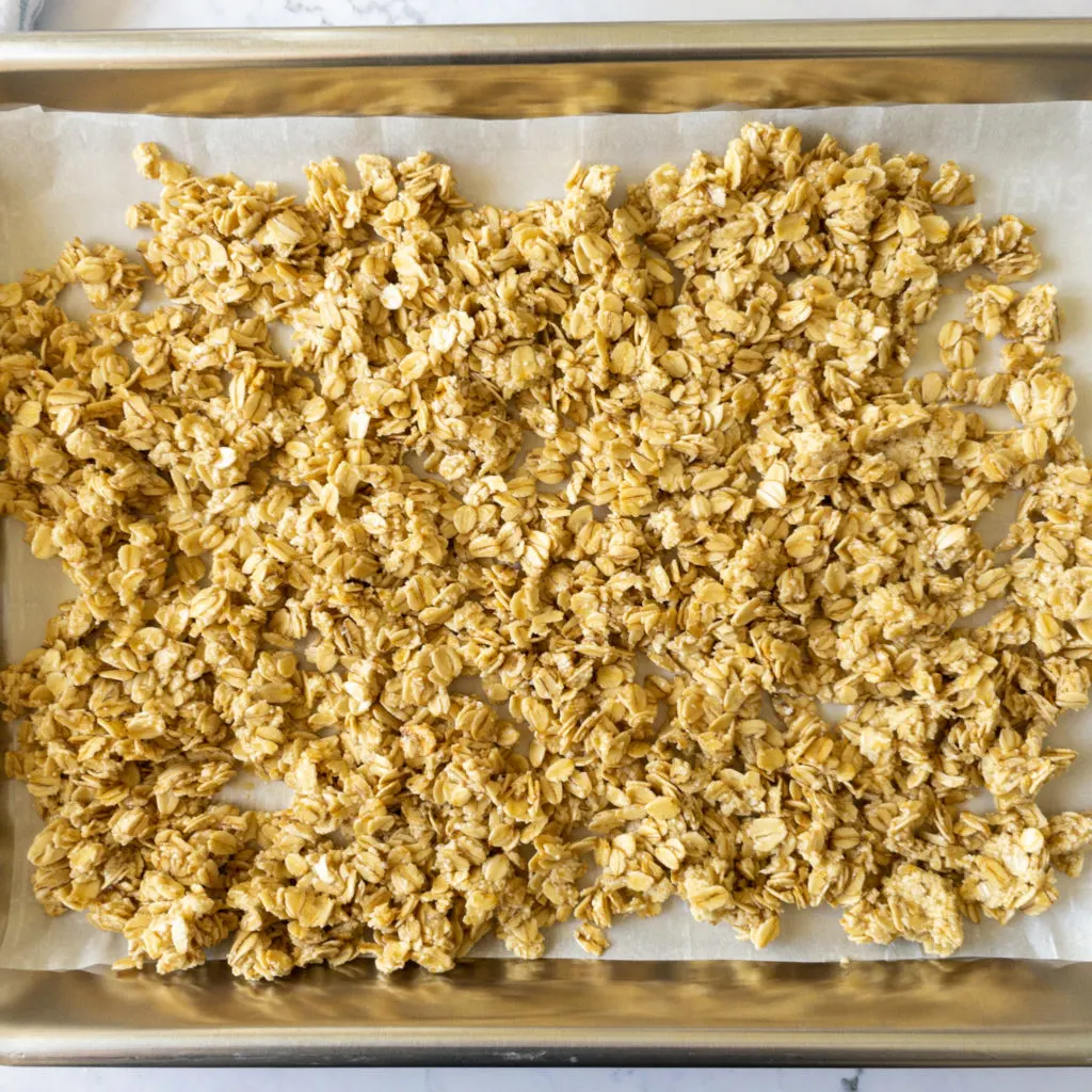 oat crunch spread out on baking sheet