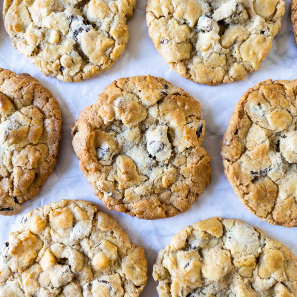 Triple chocolate chip cookies laid out on bench